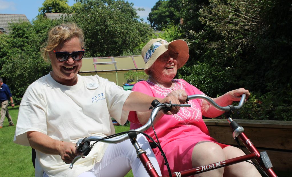 Resident at care home in garden on bike